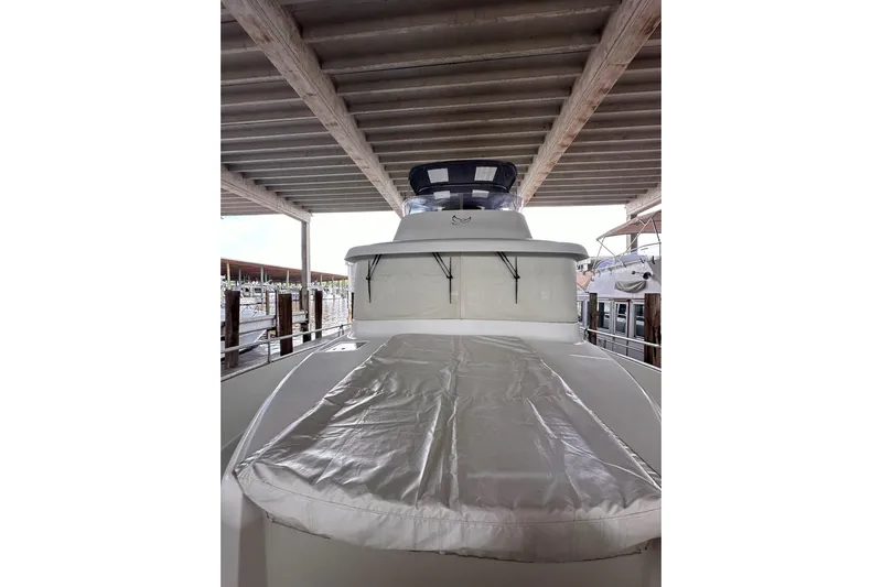 Dove Yacht Photos Pics 2015 Beneteau Swift Trawler 50 docked under a covered marina.