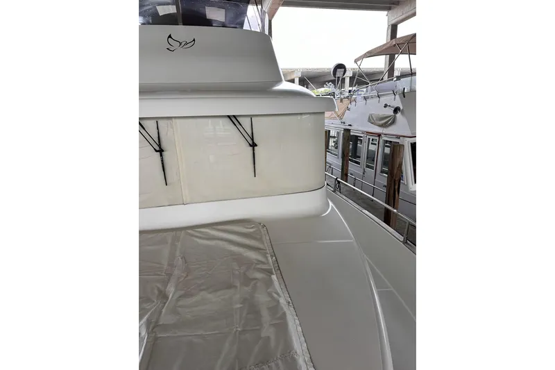 Dove Yacht Photos Pics 2015 Beneteau Swift Trawler 50, docked, showcasing sleek design and covered deck area.
