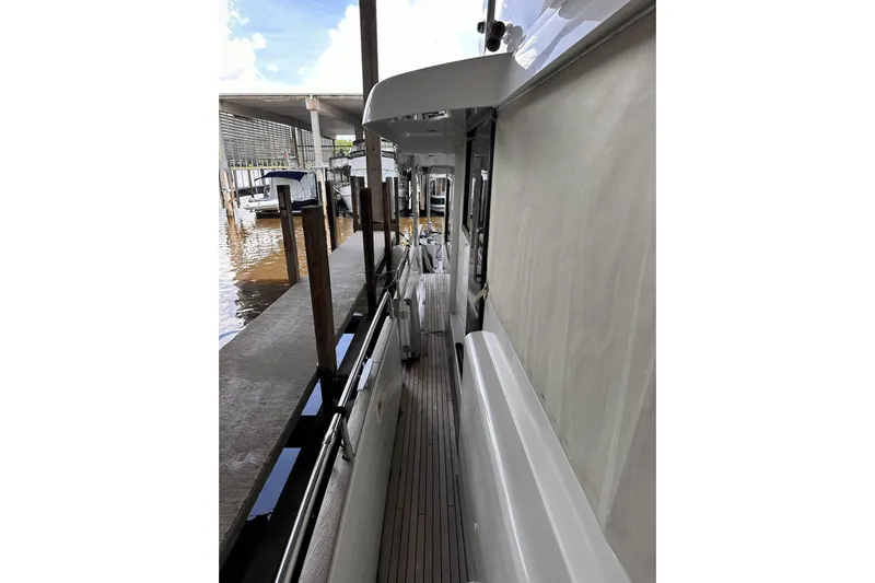 Dove Yacht Photos Pics Side deck view of 2015 Beneteau Swift Trawler 50 docked at marina.