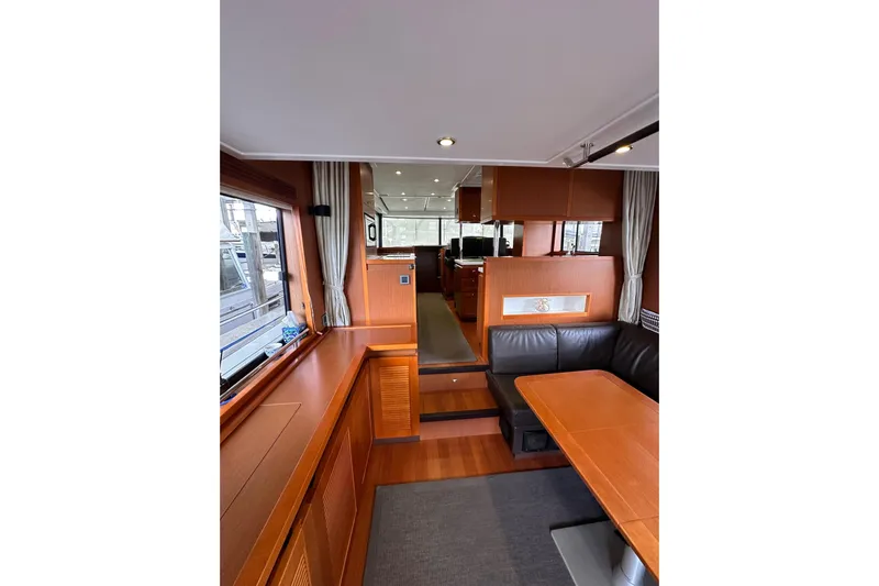 Dove Yacht Photos Pics Interior of 2015 Beneteau Swift Trawler 50, featuring wood finishes and seating area.