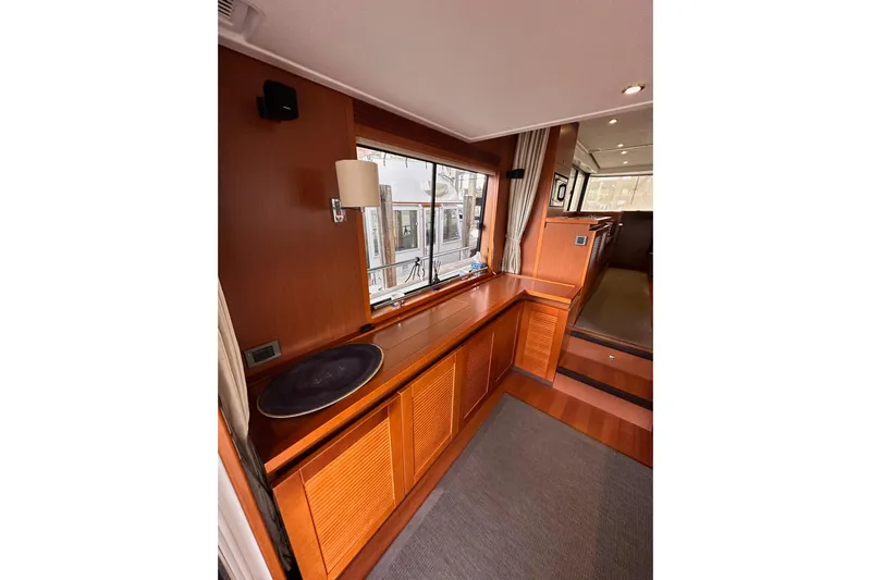 Dove Yacht Photos Pics Interior of 2015 Beneteau Swift Trawler 50 with wood finish and window view.