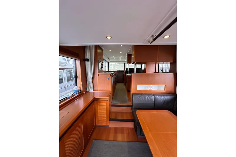 Dove Yacht Photos Pics Interior of 2015 Beneteau Swift Trawler 50, featuring wood finishes and seating area.