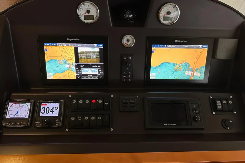 Dove Yacht Photos Pics Control panel of a 2015 Beneteau Swift Trawler 50 with navigation displays.