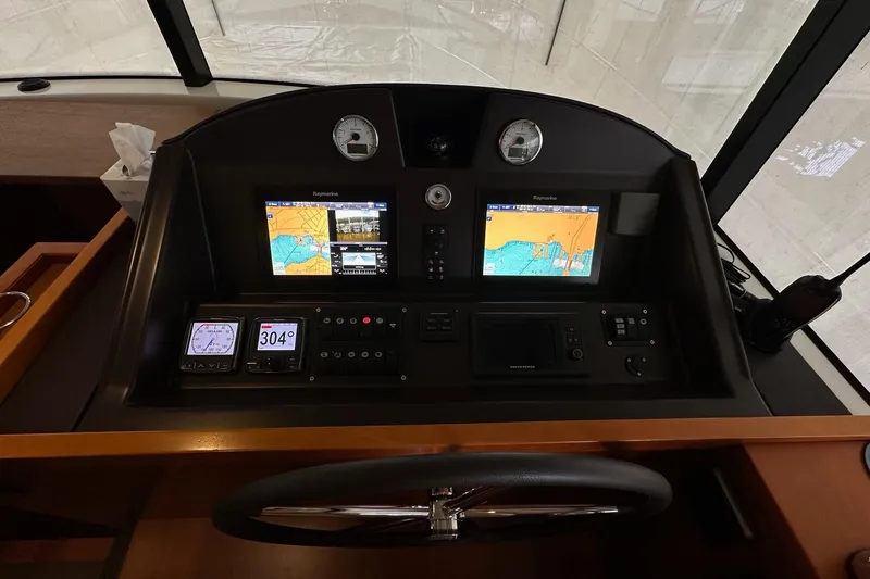 Dove Yacht Photos Pics Control panel of 2015 Beneteau Swift Trawler 50 with navigation screens and instruments.