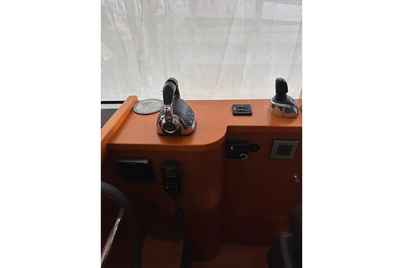 Dove Yacht Photos Pics Control panel of 2015 Beneteau Swift Trawler 50 with throttle and joystick.