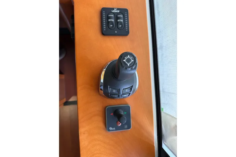 Dove Yacht Photos Pics Control panel of a 2015 Beneteau Swift Trawler 50 with joystick and buttons.