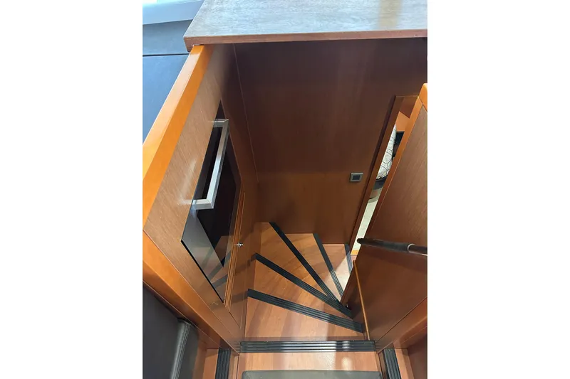 Dove Yacht Photos Pics Staircase inside 2015 Beneteau Swift Trawler 50, featuring wooden steps and sleek design.