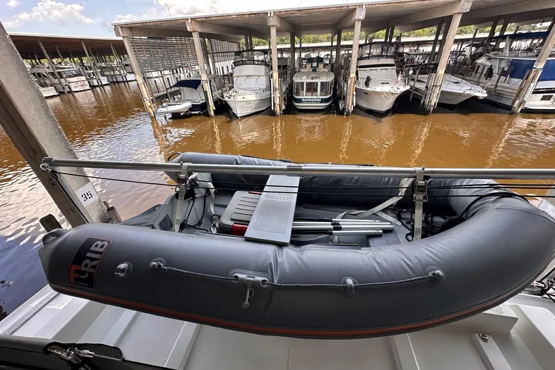Dove Yacht Photos Pics 2015 Beneteau Swift Trawler 50 with inflatable dinghy docked in a marina.