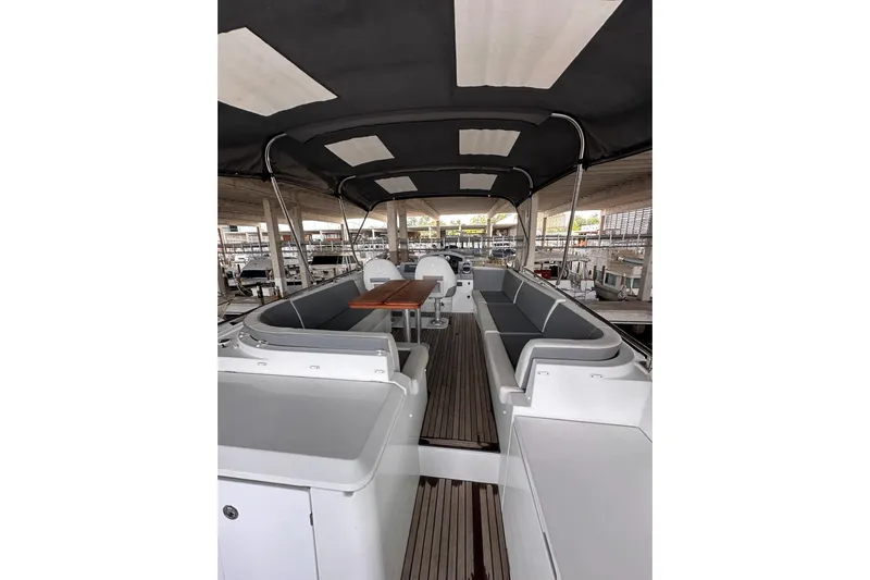 Dove Yacht Photos Pics 2015 Beneteau Swift Trawler 50 interior with seating and table under canopy.
