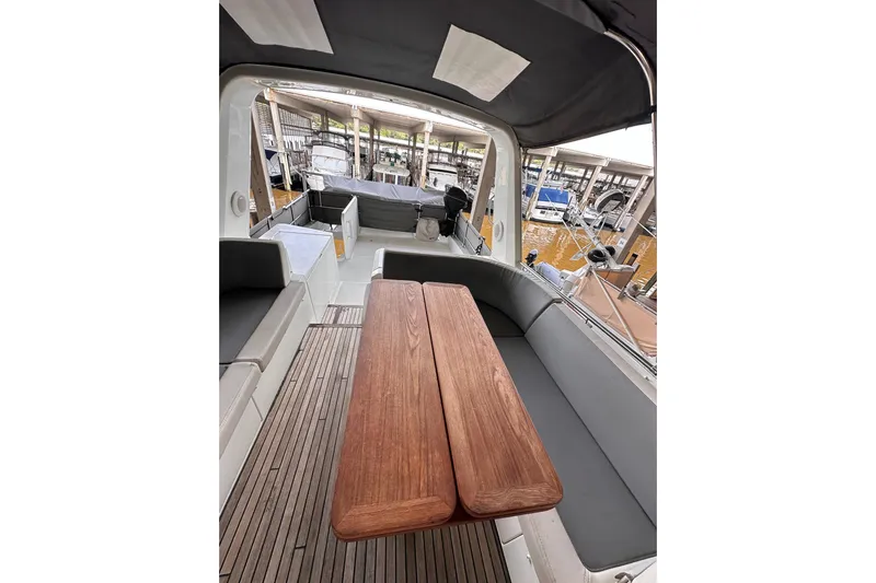 Dove Yacht Photos Pics 2015 Beneteau Swift Trawler 50 interior with wooden table and seating area.