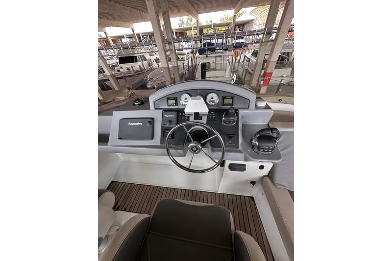 Dove Yacht Photos Pics 2015 Beneteau Swift Trawler 50 helm with navigation equipment and steering wheel.