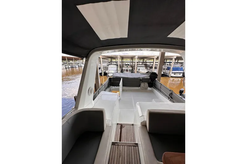 Dove Yacht Photos Pics 2015 Beneteau Swift Trawler 50 interior view at marina, showcasing seating and deck area.