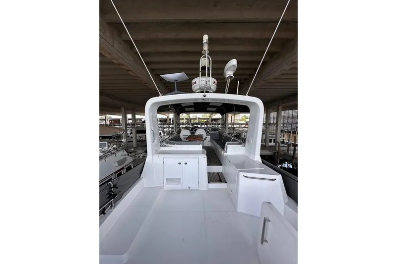 Dove Yacht Photos Pics 2015 Beneteau Swift Trawler 50 docked, showcasing spacious deck and modern design.