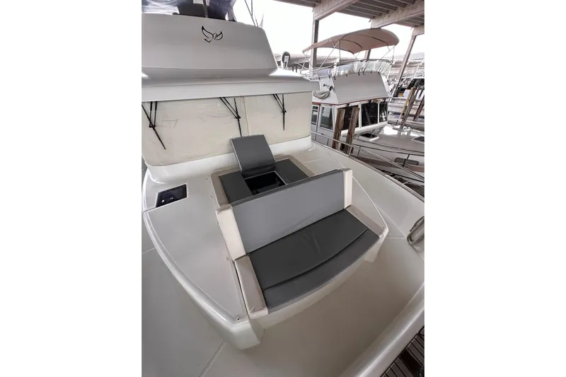 Dove Yacht Photos Pics 2015 Beneteau Swift Trawler 50 with cushioned seating on deck, docked in marina.