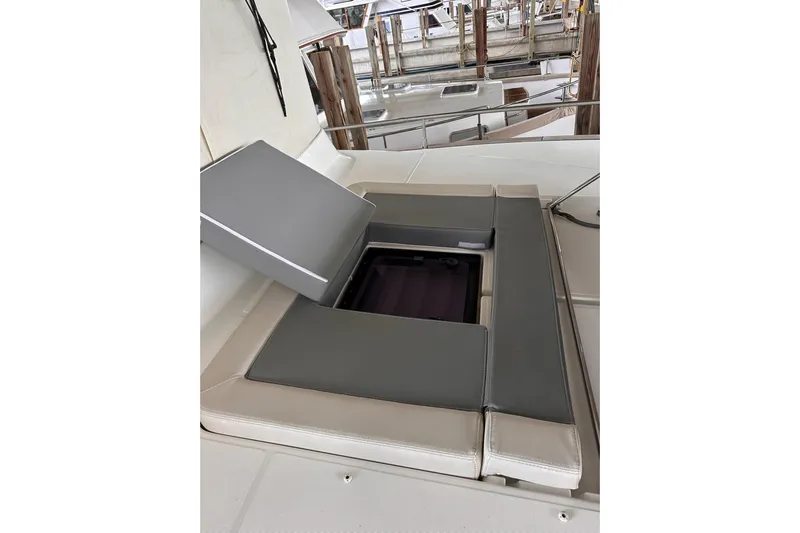 Dove Yacht Photos Pics 2015 Beneteau Swift Trawler 50 seating area with storage compartment open.