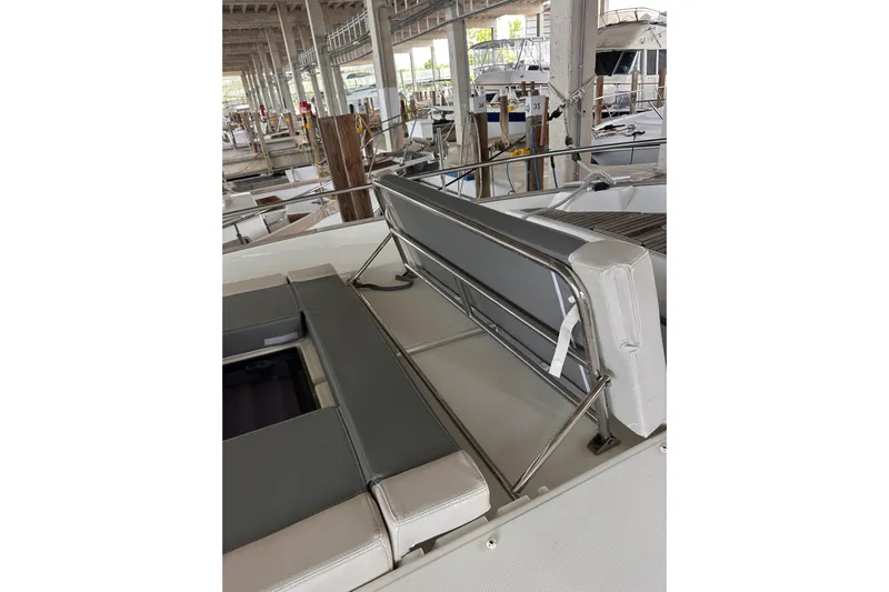 Dove Yacht Photos Pics 2015 Beneteau Swift Trawler 50 interior with gray seating in a marina setting.