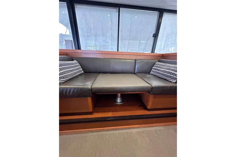 Dove Yacht Photos Pics Luxurious interior of 2015 Beneteau Swift Trawler 50 with leather seating and striped cushions.