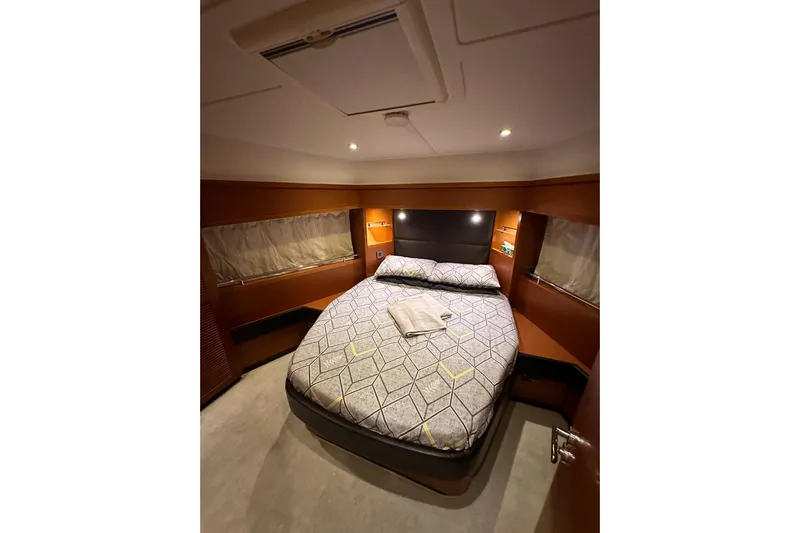 Dove Yacht Photos Pics Cozy bedroom in 2015 Beneteau Swift Trawler 50 with modern decor and ambient lighting.
