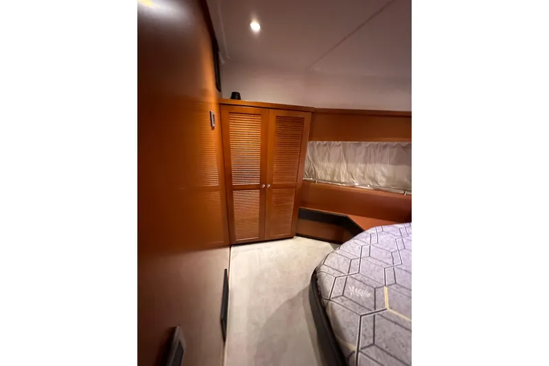 Dove Yacht Photos Pics 2015 Beneteau Swift Trawler 50 cabin interior with wooden closet and bed.