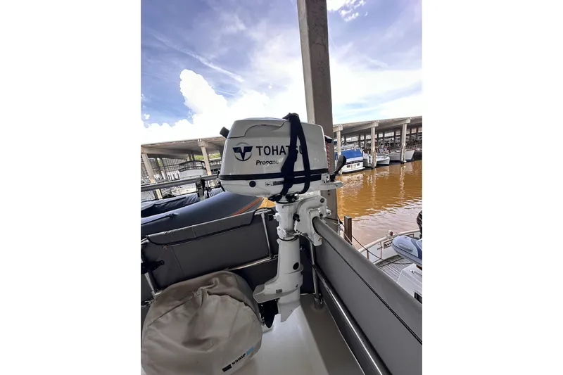 Dove Yacht Photos Pics Tohatsu outboard motor on 2015 Beneteau Swift Trawler 50, docked at marina.