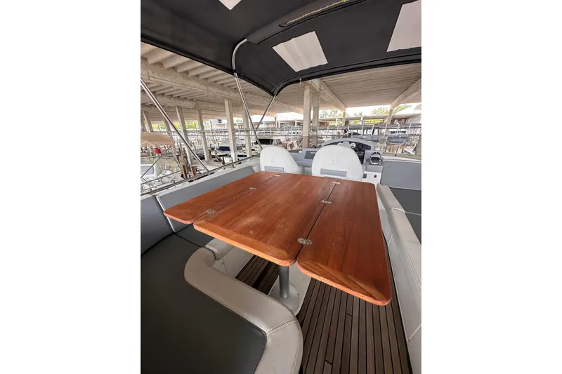 Dove Yacht Photos Pics 2015 Beneteau Swift Trawler 50 interior with wooden table and seating area.