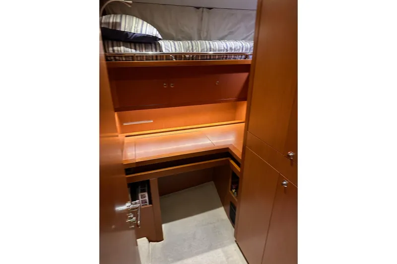 Dove Yacht Photos Pics Interior cabin of 2015 Beneteau Swift Trawler 50 with wooden furnishings and bunk bed.