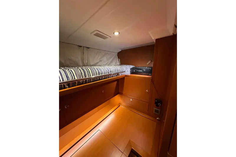Dove Yacht Photos Pics Cozy cabin interior of 2015 Beneteau Swift Trawler 50 with striped bedding.