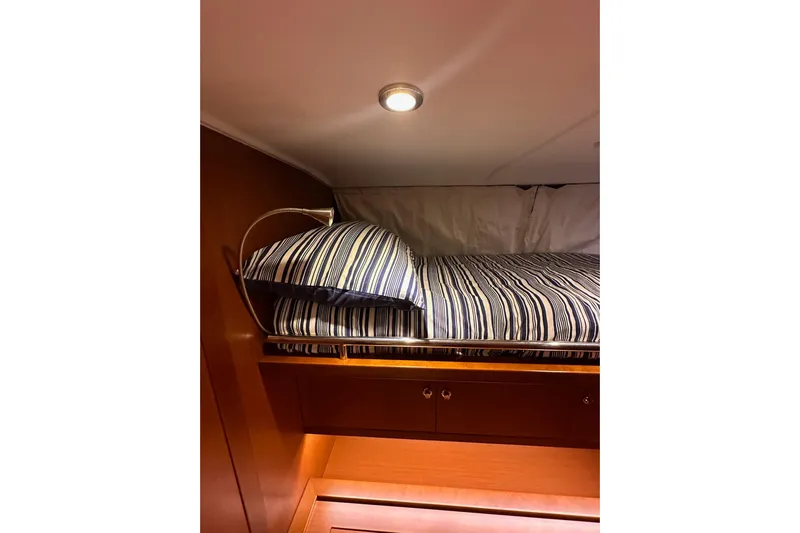 Dove Yacht Photos Pics Cozy cabin bed in 2015 Beneteau Swift Trawler 50 with striped bedding.