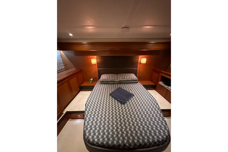 Dove Yacht Photos Pics Luxurious bedroom interior of 2015 Beneteau Swift Trawler 50 with modern decor and lighting.