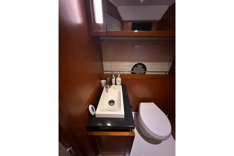 Dove Yacht Photos Pics Luxurious bathroom in 2015 Beneteau Swift Trawler 50 yacht, featuring modern sink and toilet.