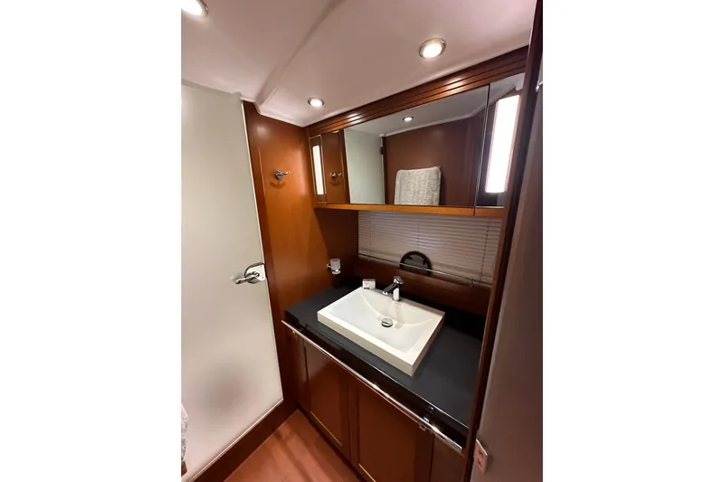 Dove Yacht Photos Pics Luxurious bathroom interior of 2015 Beneteau Swift Trawler 50 with modern sink and wood finish.