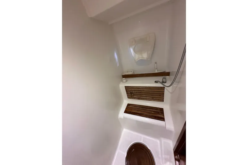 Dove Yacht Photos Pics 2015 Beneteau Swift Trawler 50 bathroom with wooden accents and showerhead.