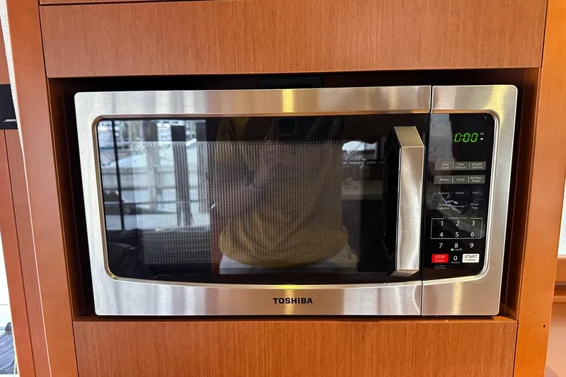 Dove Yacht Photos Pics Toshiba microwave in 2015 Beneteau Swift Trawler 50 kitchen, wood paneling background.