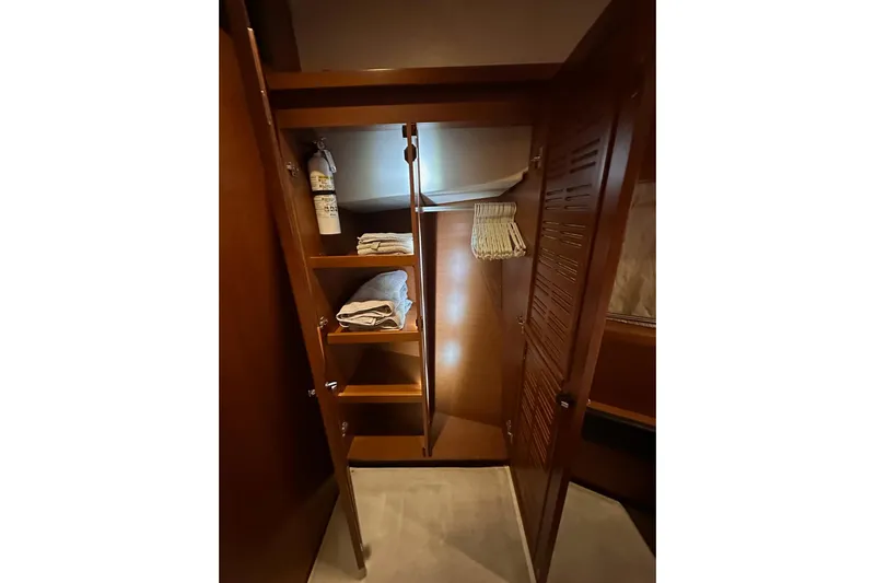 Dove Yacht Photos Pics 2015 Beneteau Swift Trawler 50 interior closet with shelves and fire extinguisher.