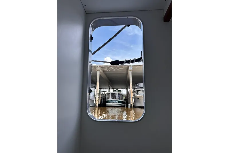 Dove Yacht Photos Pics View from Beneteau Swift Trawler 50, 2015, showing marina and boats through window.