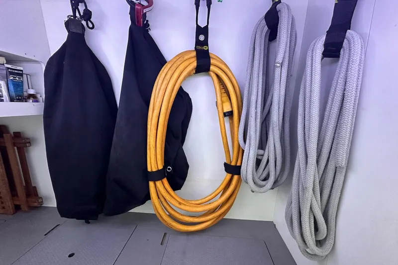 Dove Yacht Photos Pics Storage area on 2015 Beneteau Swift Trawler 50 with ropes and equipment neatly organized.