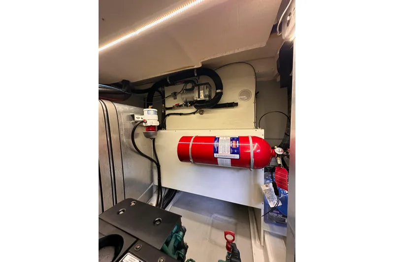 Dove Yacht Photos Pics Engine room of 2015 Beneteau Swift Trawler 50 with fire extinguisher and equipment.