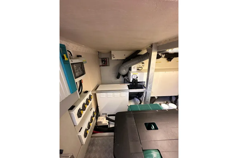 Dove Yacht Photos Pics Engine room of 2015 Beneteau Swift Trawler 50, showcasing electrical panels and ventilation system.