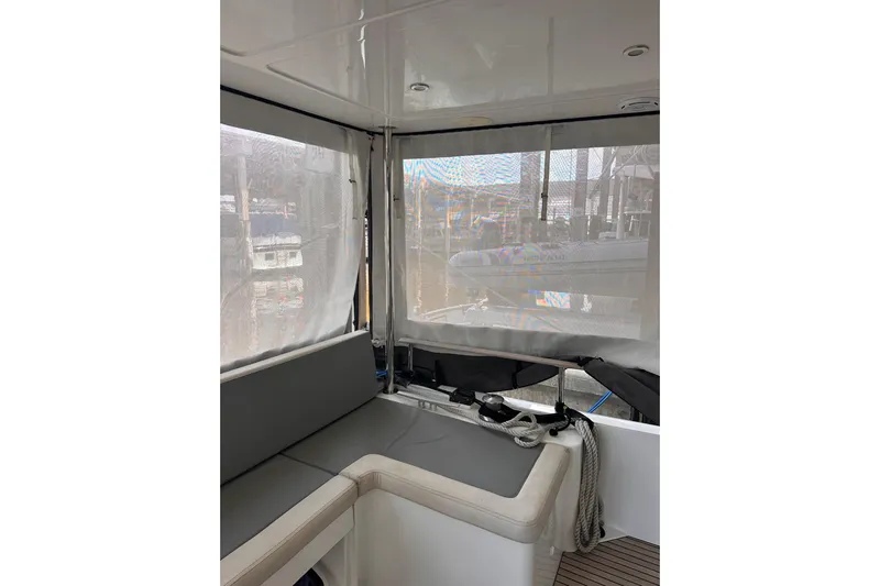 Dove Yacht Photos Pics Interior view of 2015 Beneteau Swift Trawler 50 with seating and covered windows.