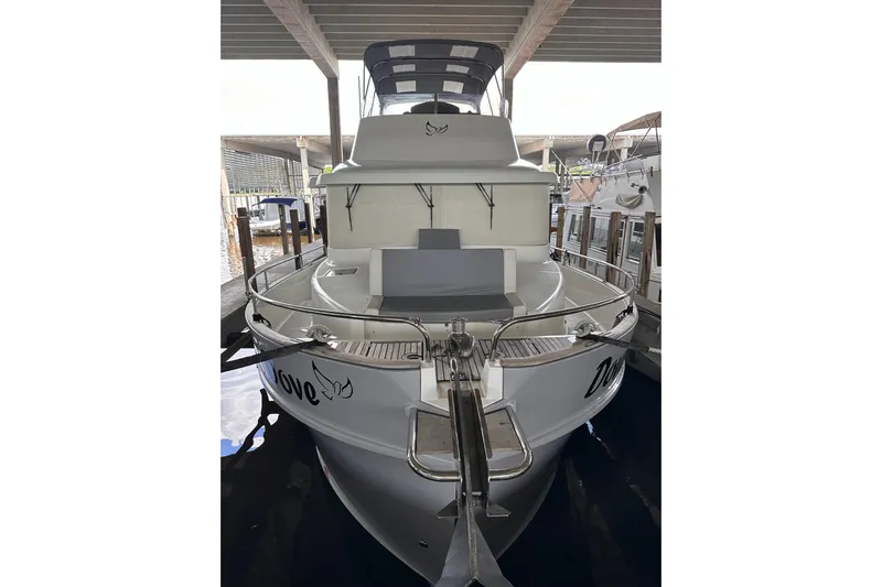 Dove Yacht Photos Pics 2015 Beneteau Swift Trawler 50 docked under shelter, rear view.