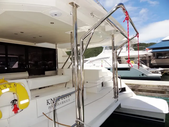 Livitup Yacht Photos Pics 2017 Leopard 43 Powercat yacht docked at marina, featuring sleek design and spacious deck.