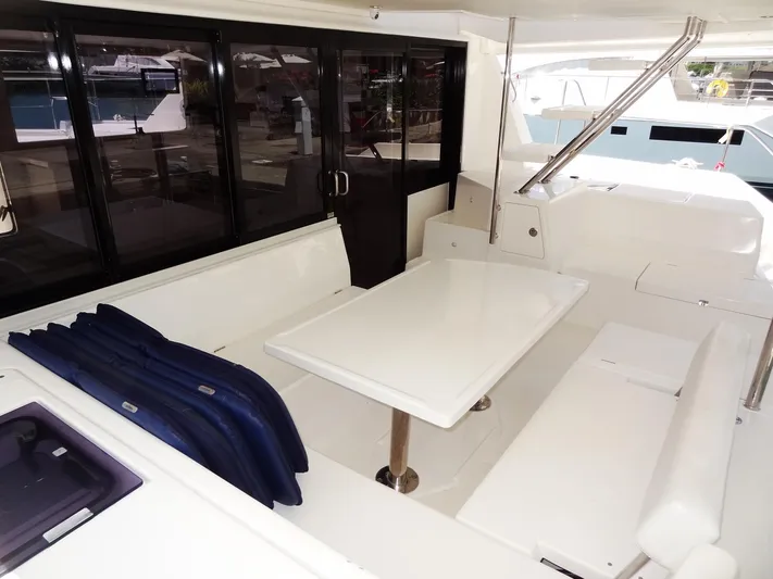 Livitup Yacht Photos Pics Spacious seating area on 2017 Leopard 43 Powercat yacht with white table and cushions.