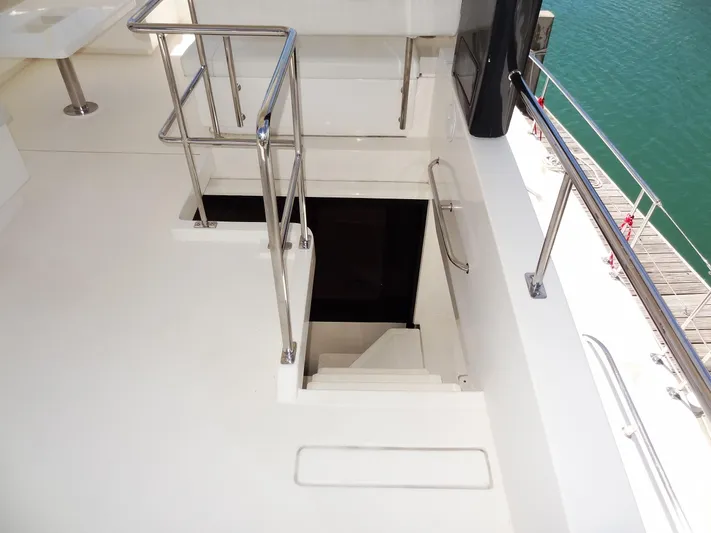 Livitup Yacht Photos Pics Staircase on 2017 Leopard 43 Powercat yacht deck, featuring sleek railings and ocean view.