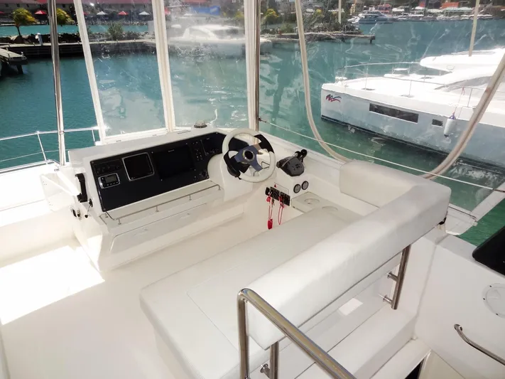 Livitup Yacht Photos Pics 2017 Leopard 43 Powercat helm with marina view, featuring modern controls and seating.