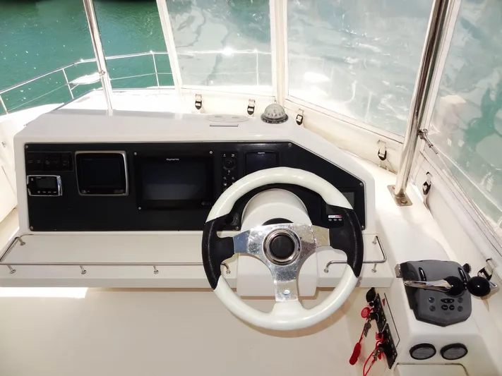 Livitup Yacht Photos Pics 2017 Leopard 43 Powercat helm with steering wheel and navigation controls.