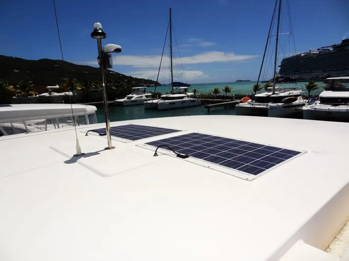 Livitup Yacht Photos Pics 2017 Leopard 43 Powercat with solar panels docked in a scenic marina.