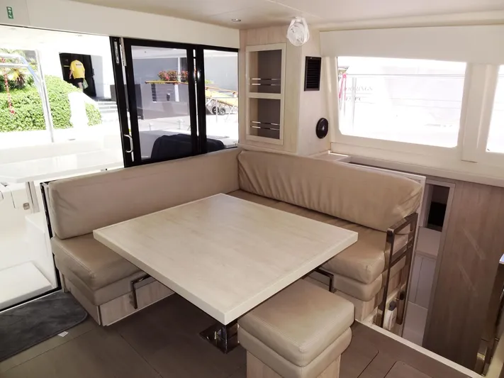 Livitup Yacht Photos Pics Interior of 2017 Leopard 43 Powercat with beige seating and dining table.