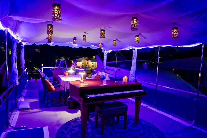 Amore Yacht Photos Pics Luxurious 1996 Catamaran Cruisers Aqua Cruiser 44 with elegant lighting and piano on deck.