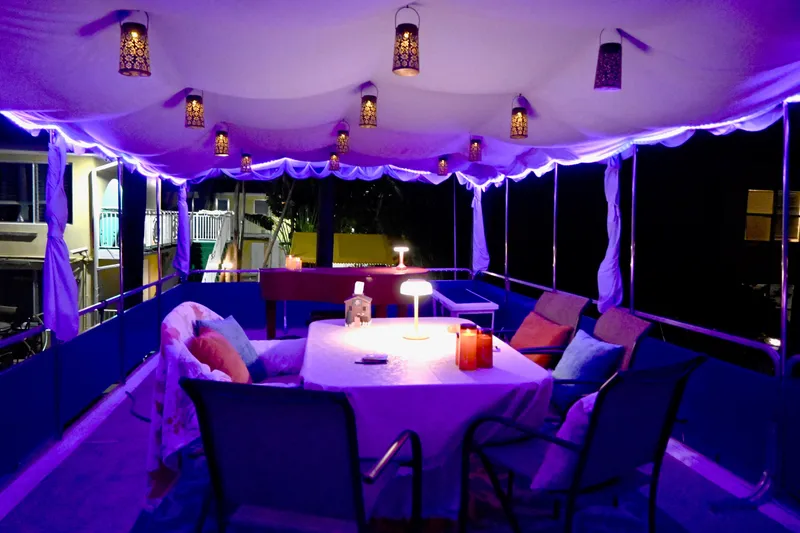 Amore Yacht Photos Pics 1996 Catamaran Cruisers Aqua Cruiser 44 with cozy, illuminated deck and seating area.