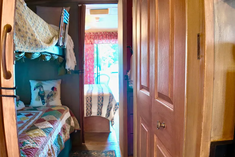 Amore Yacht Photos Pics Interior of 1996 Catamaran Cruisers Aqua Cruiser 44 with cozy bunk beds and colorful decor.